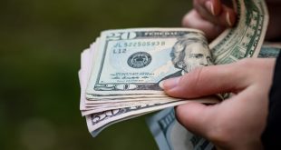امرأة تعد أوراق نقدية من فئة الدولار الأمريكي. (أرشيفية)